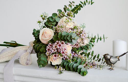 A lovely, cool arrangement of eucalyptus branches and roses