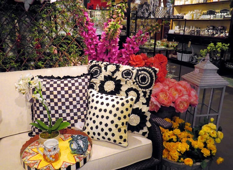 Household furnishings and tall, colorful floral arrangements coexist on our showroom floor