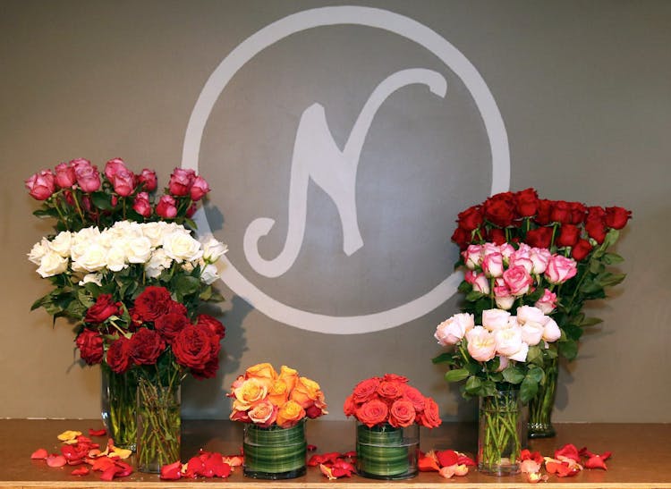 Flaunted by bouquets, the Neubauer's logo is painted on a gray wall